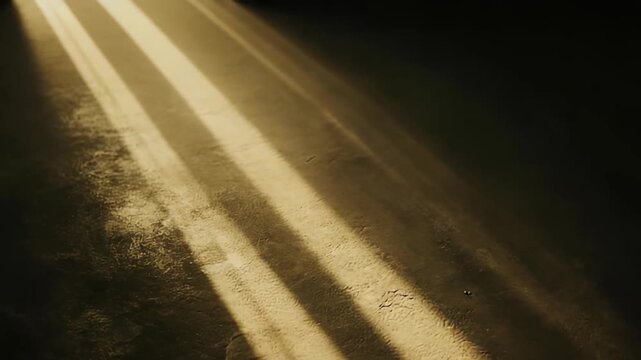 Sunlight creating parallel light beams and dark shadows on a textured, rough surface, offering a calming background and abstract pattern with natural soft lighting