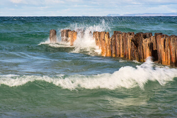 waves splashing on old wooden pilings