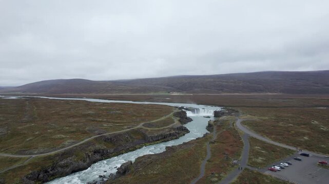 Aerial shot of Godafoss waterfall and the nearby parking lot in northern Iceland
