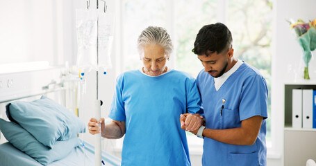 Obraz premium Physiotherapist, senior woman and support for walking, help and holding hands with IV drip at hospital. Man, elderly patient and care for recovery, injury or rehabilitation with steps at clinic
