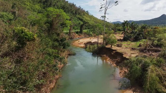 Drone captures aftermath of typhoon along muddy Taytay River in lush valley