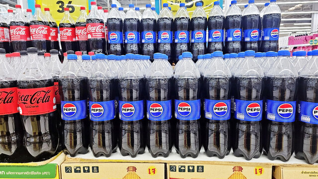 Soda Array: A neat and colorful arrangement of soda bottles, featuring Coca-Cola and Pepsi, arranged neatly on a retail shelf. Thailand, January 27, 2026