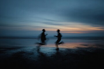 Motion blur of two figures running on a wet beach at dusk