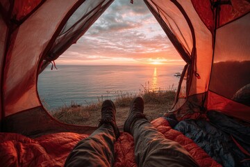 Inside tent, legs point to stunning ocean sunset view