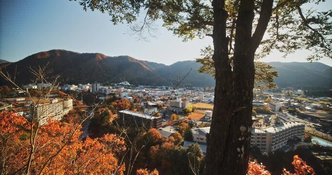 Sunrise shining over beautiful Nikko, Japan during autumn - panning shot in slow motion