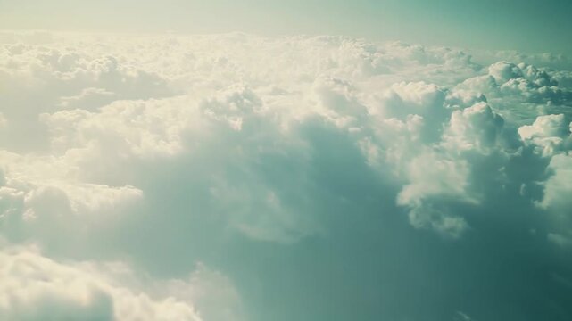 Expansive field of soft, voluminous cumulus clouds stretching to the horizon beneath a clear blue sky, creating a tranquil, ethereal aerial cloudscape ideal for backgrounds