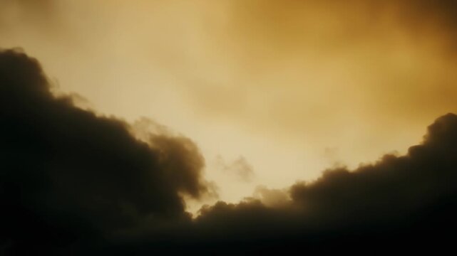Warm golden light illuminating a dramatic cloudy sky, with dense storm clouds parting, showing a bright opening and creating an atmosphere of mystery and hope