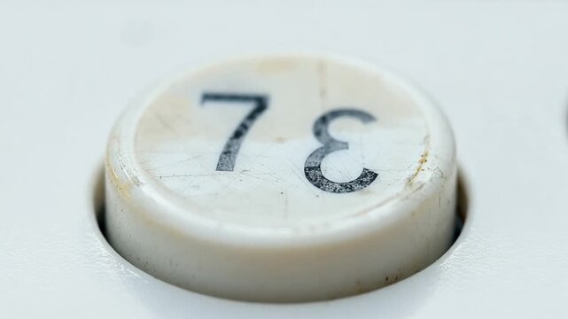 Close-up of a Vintage Calculator Buttons with a Seven and a Greek Epsilon