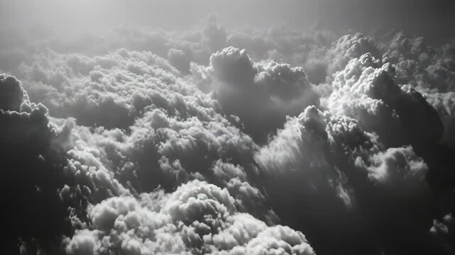 Atmospheric cumulus clouds stretching across the sky, captured from an airplane in a dramatic black and white high contrast composition, conveying concepts of vastness, weather, and freedom