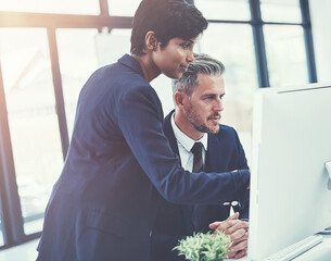 Computer, business people and cooperation in office, planning and feedback with compliance update. Desktop, team and discussion with manager for policy review, briefing or problem solving in meeting