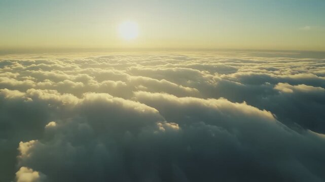 Expansive view of a limitless sky and an ocean of rolling clouds, with the bright sun warm and glowing at the horizon, creating a serene and ethereal atmosphere