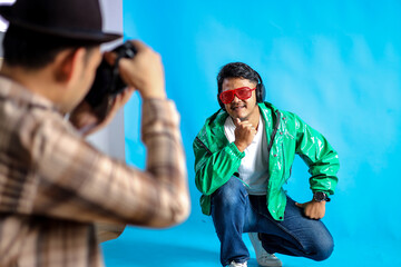 Photographer Capturing Stylish Man in Green Jacket and Red Sunglasses