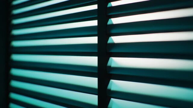 Interior blinds filtering sunlight creating parallel abstract light beams and dark shadows illuminating the wall, suggesting privacy, calm, and atmospheric room conditions