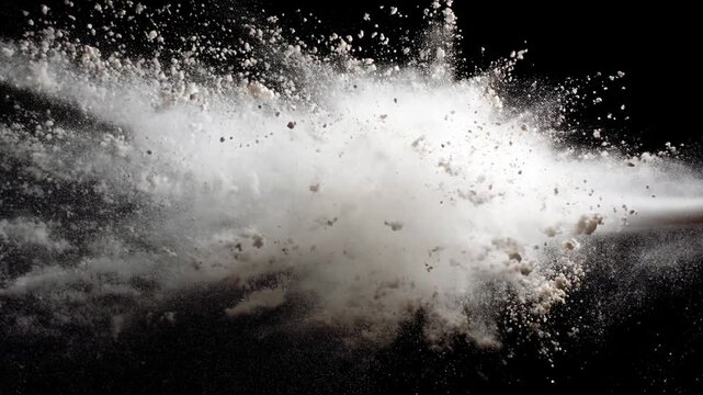 Black cloud particles with white powder burst concept. The image captures an explosion of fine particles against a dark background.