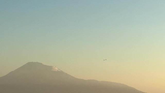 NATO fighter jet over a city near Mount Ararat and Yerevan, Two fighter jets in the sky perform a dangerous maneuver, pilots are preparing, dangerous turns. War. Middle East. 10.03.2025. High quality 
