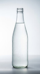 Sparkling lemonade bottle standing isolated on a pristine white background, showcasing clear glass and refreshing beverage with subtle condensation droplets