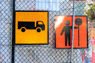 Road Work Sign on Construction Site Fence