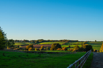 Beautiful rural sunset landscape in the green fields meadows in the Cotswolds, England