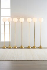 A row of modern gold floor lamps with round white shades