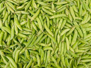 Fresh  green peas heap at market place	
