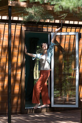 Mindfulness and feel-good moments.  lifestyle portrait smiling middle aged woman stands near his country house. mental health. Enjoying the little things