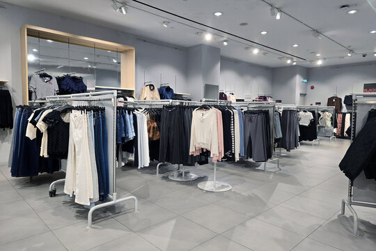 Penang, Malaysia &ndash; Nov 30, 2025: Interior view of a H&M retail store showcasing women&rsquo;s clothing displayed on racks, including casual tops, skirts, and denim.