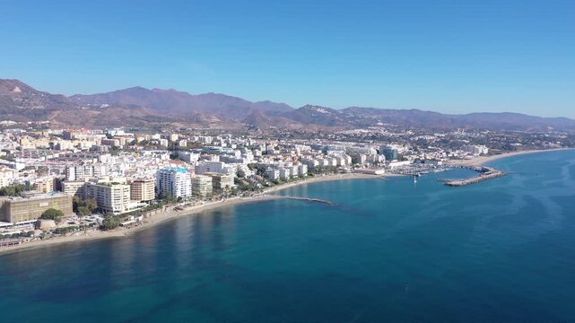 Picturesque autumn view from drone of coastal Mediterranean city of Marbella on background of mountain range overlooking sea harbour on summer day, Andalusia, Spain