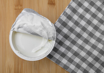 Thick white cream in a small, open plastic cup