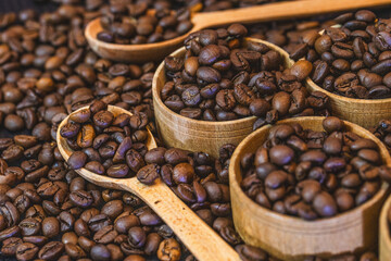 Fototapeta premium Coffee beans background with rich brown tones and natural texture. Roasted coffee beans close-up, creating a warm and aromatic backdrop ideal for coffee shops, cafes, menus, packaging, branding, food 