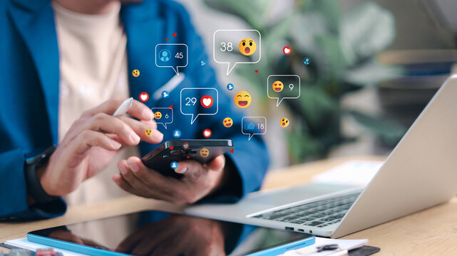 Businesswoman using smartphone with social media notifications floating around. Concept of online engagement, digital marketing, influencer, likes, comments, and social interaction.