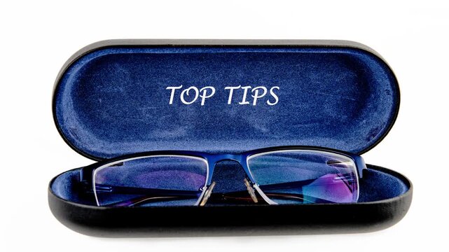 Modern blue-framed glasses are stored securely in an open protective case with a pop-up message TOP TIPS