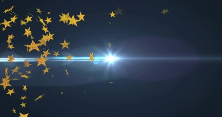 Obraz premium Glittering textured golden stars drifting left on navy gradient toward blue lens flare, copy space