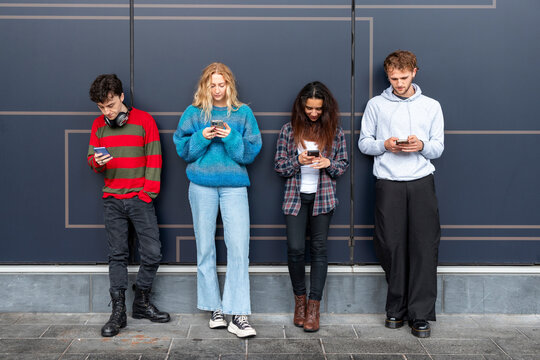People using mobile phones outdoors in urban setting with digital addiction