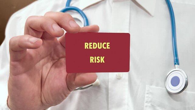 A doctor wearing a white coat and stethoscope holds a red rectangular card. The words Reduce Risk progressively appear on the card, emphasizing a crucial health message