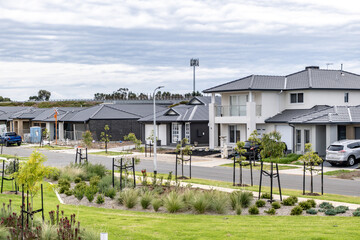 Modern suburban street in an outer suburb of Melbourne, Australia, featuring newly built detached...