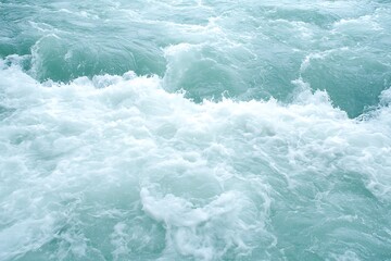 Fototapeta premium Turbulent Ocean Waves Churning with White Foam Against a Calm Aqua Blue Background