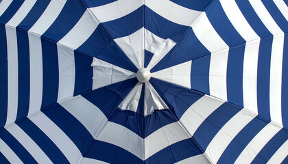 Overhead view of a blue and white striped, open sunshade, showing the geometric design