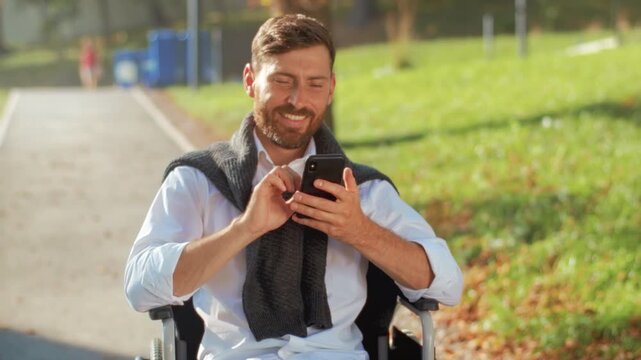 Man with phone smiling outdoors, Casual outdoor environment showing social interaction and accessible living