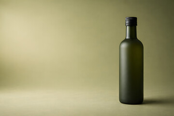 Matte green glass bottle of olive oil standing upright on a gradient green background. Minimalistic product photo with moody lighting.