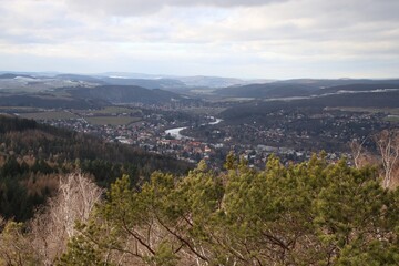 Obraz premium view from the top of the hill to the mountains and the river in the valley