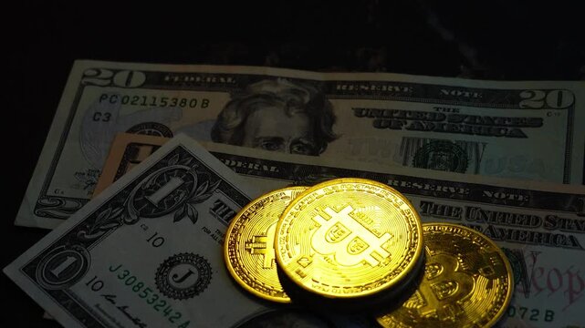 Bitcoin BTC coin with 100 dollars bills. Digital crypto coin and cryptocurrency. Investments for the investor. Concept of exchange market and online trading. Trading in bull and bear markets