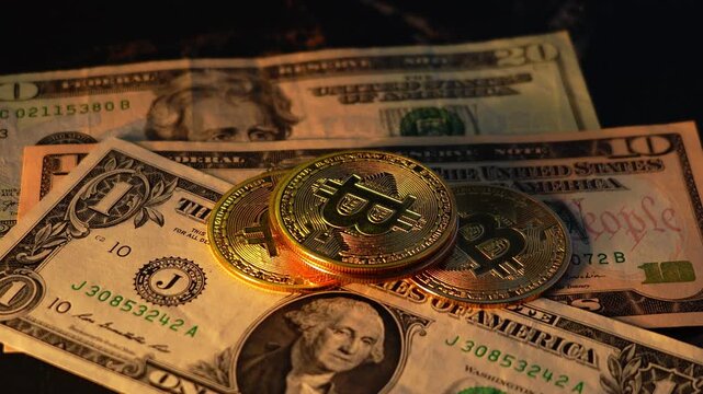 Bitcoin BTC coin with 100 dollars bills. Digital crypto coin and cryptocurrency. Investments for the investor. Concept of exchange market and online trading. Trading in bull and bear markets