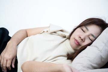 Peaceful middle-aged Asian woman taking a nap on sofa, sleeping deeply at home. Mature female resting eyes, dreaming, or recovering from fatigue in living room