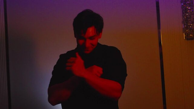 Man dancing in dark room with lights