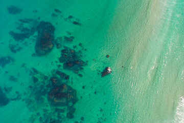 Fototapeta premium Turquoise sea water meeting sandy beach The concept of vacation