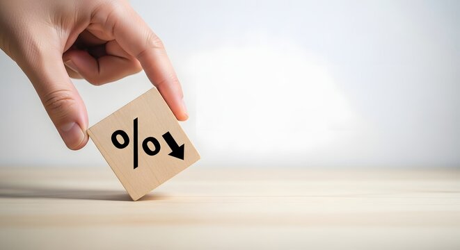 Hand adjusting percentage sign on wooden block