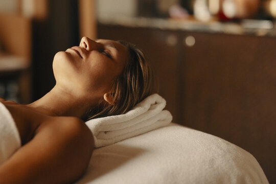 Woman enjoying facial beauty treatment at spa
