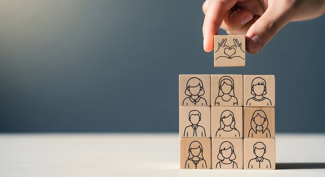 A hand placing a wooden block with a person on top