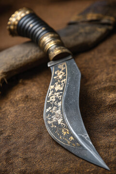 A close-up of traditional Nepalese 'Gorkhali' knife (Khukuri), its distinctive curved blade, symbolizing bravery and cultural heritage.