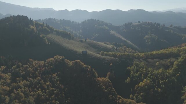 Ungraded Log Descending Aerial View of Backlit Misty Mountain Layers at Sunset
